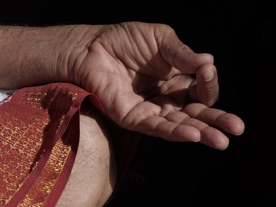 Close up of hands in a mudra position.