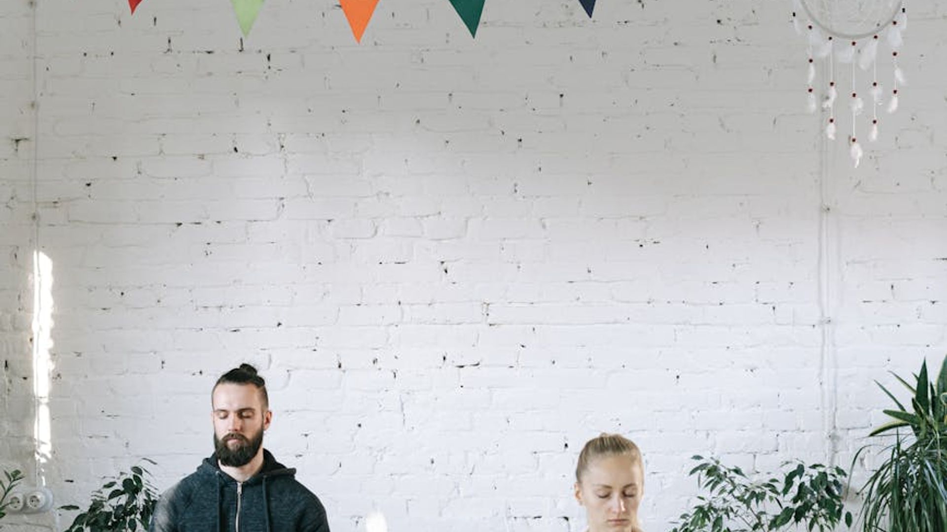 Serene yoga studio with natural light and minimalist decor.